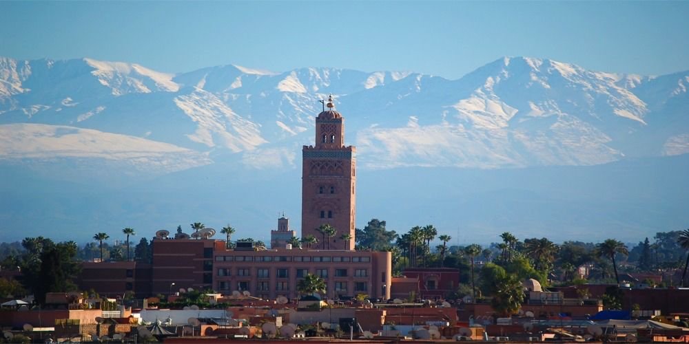 Marrakech city view with mountains and Koutoubia mosque, Morocco